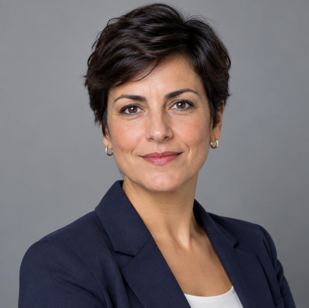 Studio portrait of a Portuguese woman with short dark hair smiling
